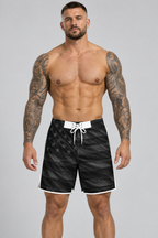 Tattooed male model wearing black American flag board shorts